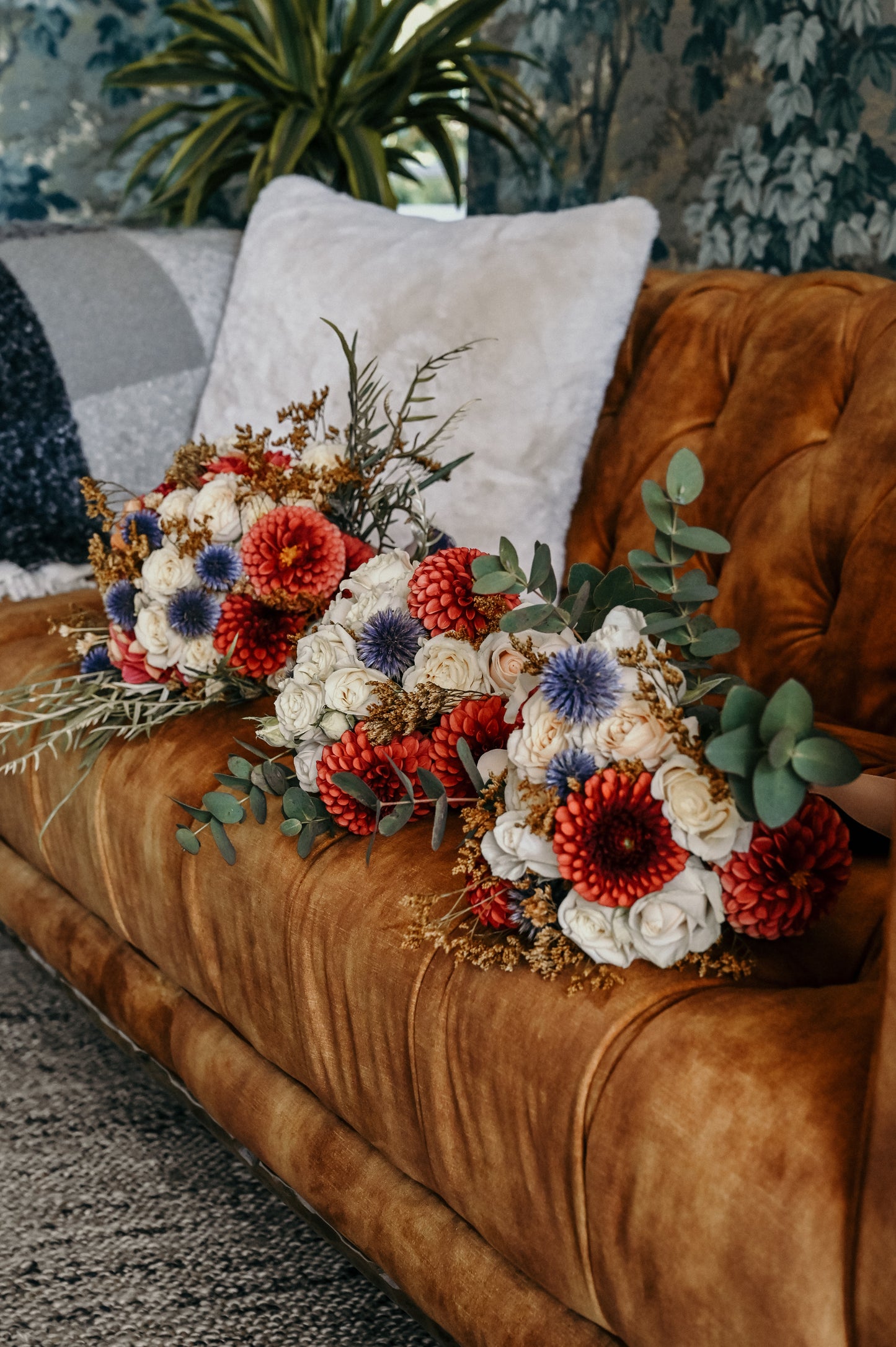 Rustic statement bridal flowers for the bride and bridesmaids. Copper dahlia and blue echinops to make them pop. Texture and colour on point - The Wildstyler bridal flowers Kapiti, NZ