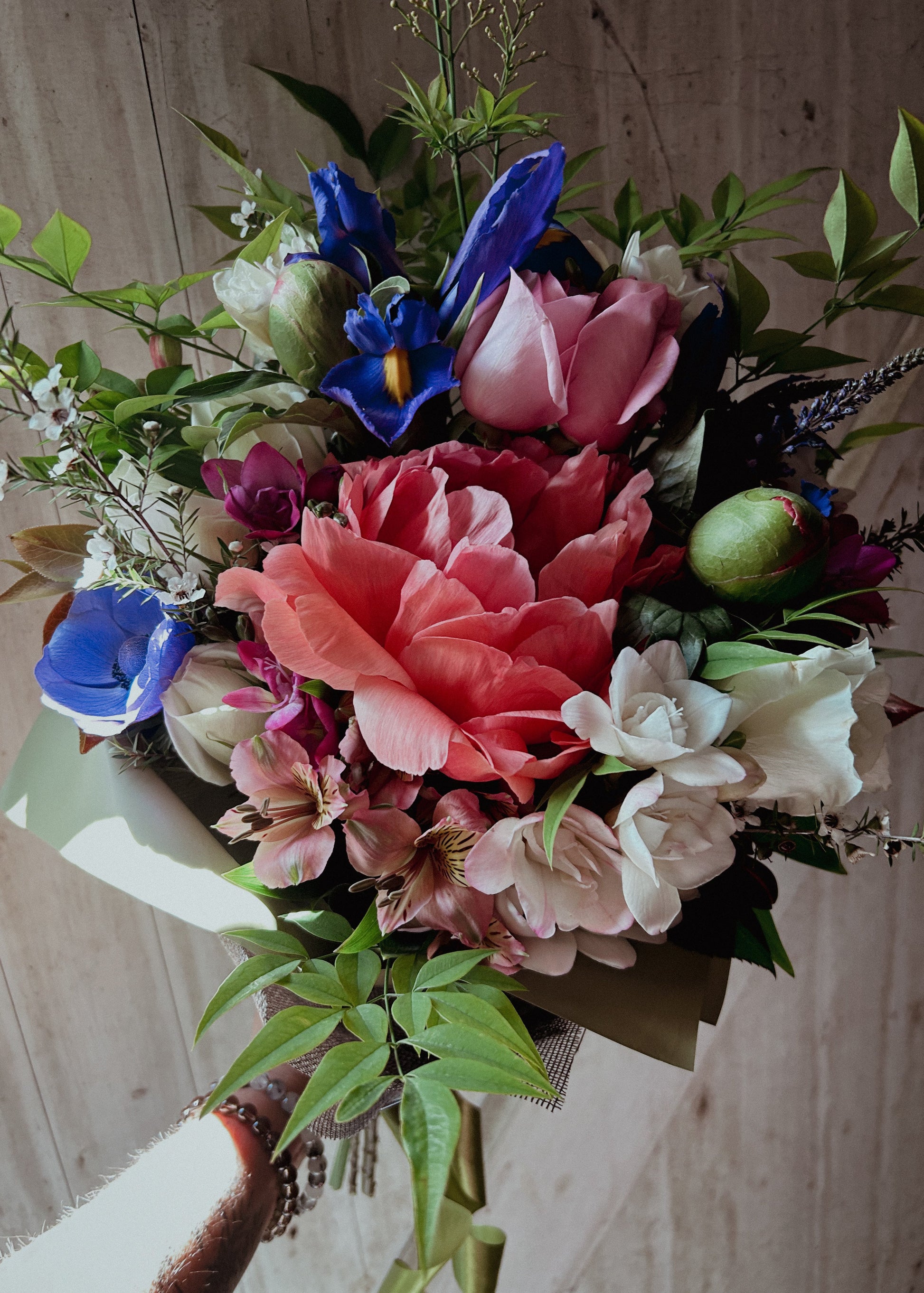 Bouquet of colorful flowers with a wooden background