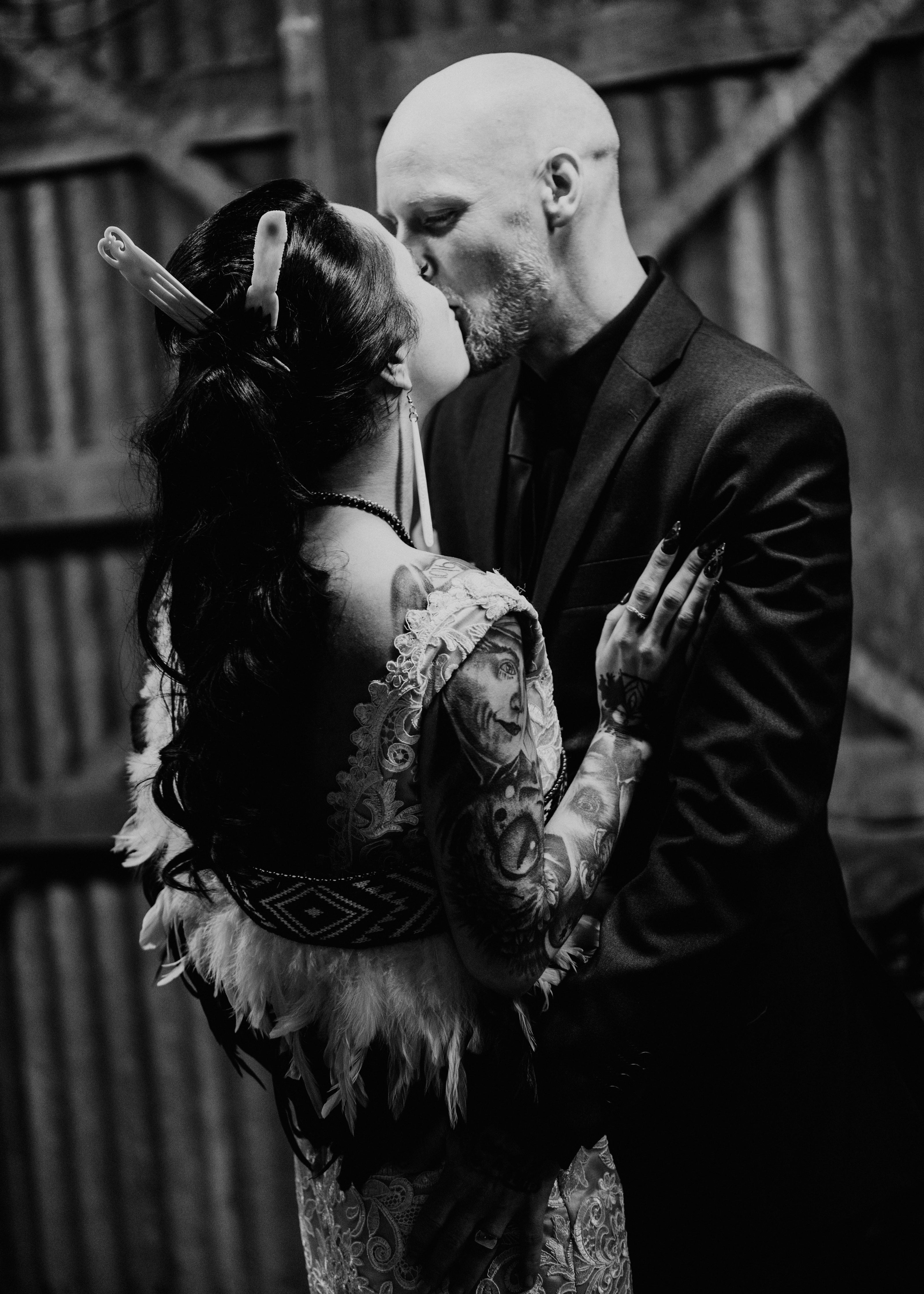 Black and white photo of a couple embracing outdoors.